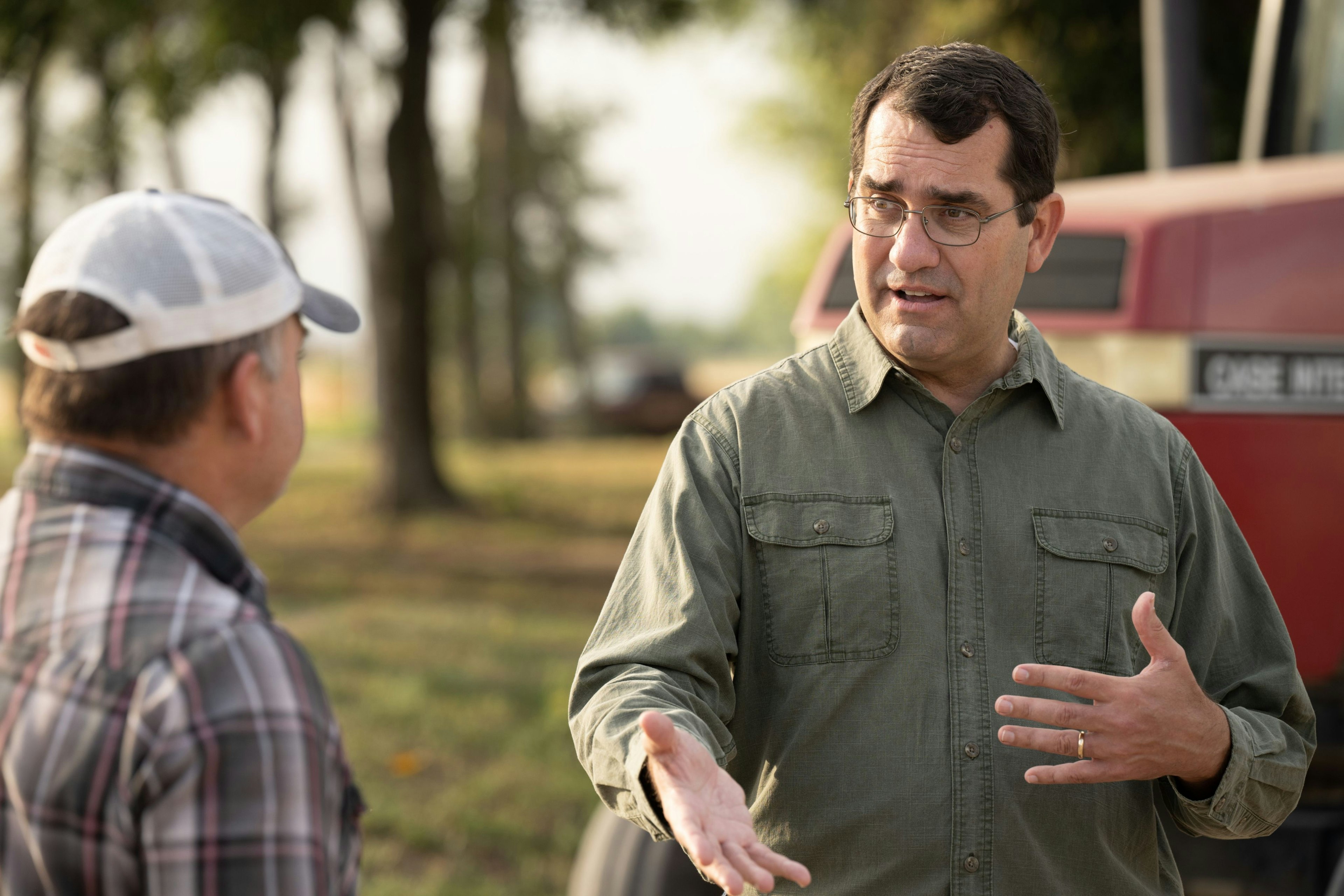 Derek Schmidt talking with a farmer